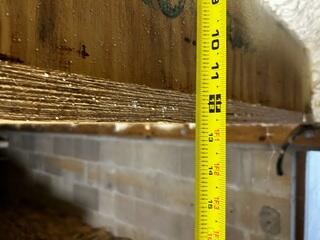 During the inspection of the home's crawl space, the LRE Design Specialist discovered that the floor joists had significantly dropped due to a lack of stable support from below.