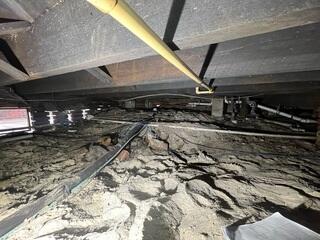 The crawl space inspection conducted by the LRE Design Specialist revealed insufficient support for the home's floor joists, causing them to slope.