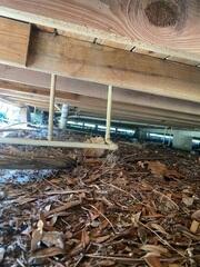 An inspection of the home's crawl space by an LRE Design Specialist revealed a lack of support for the wooden floor joists, causing them to slope.