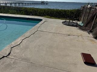 The homeowner's concrete pool deck had developed numerous large cracks over time due to the settling and erosion of the underlying soil.