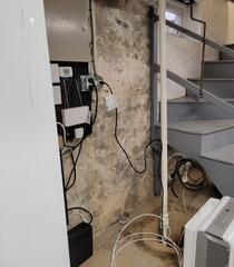 This basement had water seepage issues and an old sump pit where we would install our system.