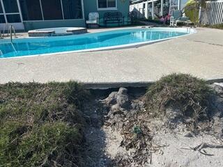 Heavy rainfall and flooding from Hurricanes Helene and Milton caused severe soil erosion beneath the homeowner's pool deck.