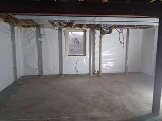 The completed basement features our full waterproofing system-including CleanSpace®, WaterGuard®, and a DoubleSafe™ Sump Pump-paired with the PowerBrace™ system for permanent wall stabilization. A dry, secure space restored with confidence.