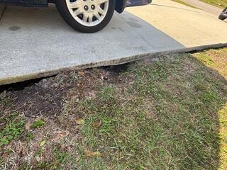 Severe soil erosion beneath the homeowner's driveway had created large voids and caused the concrete to settle and crack.