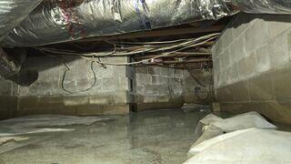 Flooding rainwater had collected in the homeowner's crawl space as a result of the absence of an effective moisture control and drainage system, putting the foundation at risk for long-term damage.