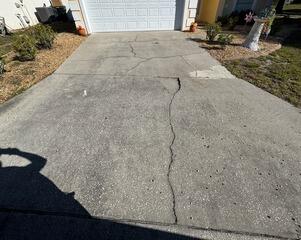The settlement of the underlying soil had caused significant damage to the homeowner's driveway, resulting in cracks and uneven slabs.