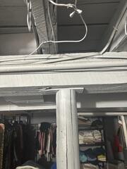 This old support system was not working to lift the joists and support the floor above.