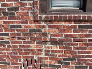 Wide Vertical Wall Crack Below Window