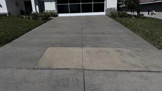 Upon inspecting the homeowner's concrete driveway, the LRE Design Specialist immediately identified uneven sections and a discolored tone across the surface, indicating potential settling and wear over time.