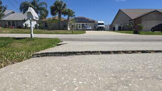 A major tripping hazard had formed in the homeowner's concrete driveway due to the slabs settling and becoming uneven.
