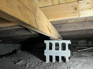 During the crawl space inspection, the LRE Design Specialist quickly noticed that numerous original block piers had settled, resulting in insufficient support for the floor joists above.