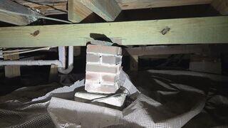 During the inspection of the home's crawl space, the LRE Design Specialist discovered that many of the original block piers had settled and deteriorated over time, compromising their ability to properly support the floor joists above.