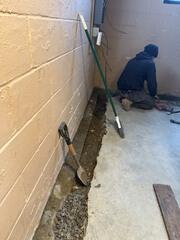 Installers prep for WaterGuard by jackhammering along the perimeter of the basement.