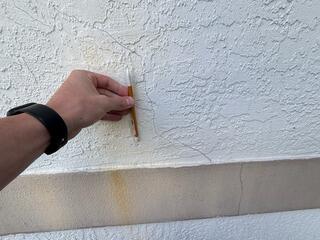 The homeowner began noticing small hairline cracks in the exterior walls of her home, prompting her to seek a professional foundation inspection.