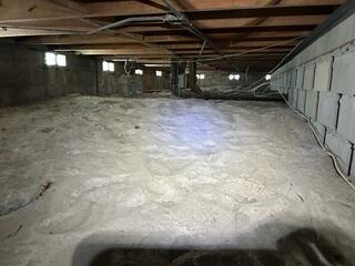 The LRE Design Specialist inspected the condominium's crawl space and identified several areas where the wooden support joists were noticeably sagging due to insufficient support from below.
