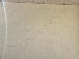 The homeowner noticed large, stair-step cracks forming in the exterior walls of their home, prompting them to seek a professional foundation inspection.