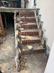 This brick staircase will be replaced with a new pressure-treated wood staircase.