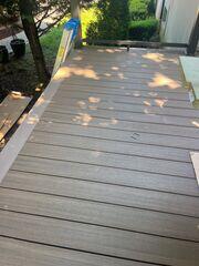 The transformation has begun. New pressure-treated wood decking is being laid out and installed on the same day.