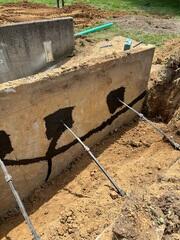 These anchors are shaped like a screw, (currently hidden underneath the soil) to help us drill them sideways into the soil. This shape also helps us prevent disturbing the soil.