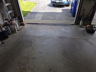 The concrete adjacent to the garage apron had begun to settle, creating an unsightly appearance and raising concerns about vehicle access. This settlement is evidenced by cracks in the foundation floor, which, if not promptly addressed, could deteriorate further over time.