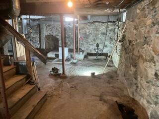 The lally columns previously installed in the basement proved inadequate for supporting the floors above, resulting in noticeable sagging and sloping. This not only causes discomfort when walking on the bouncy floors but also serves as a persistent reminder of the home's structural instability. To address this issue permanently, we initiated the installation of SmartJacks.