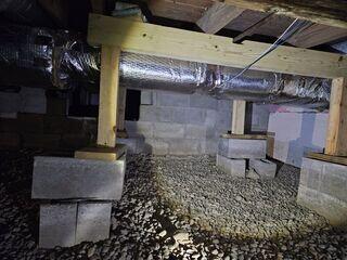 Originally, in the space, there were wooden supports connected to the joists above, but the base was attached to stacked cinder blocks. Due to the dampness in the space over time, these wood supports will begin to deteriorate, rot, and mold, leading to their failure as a support.