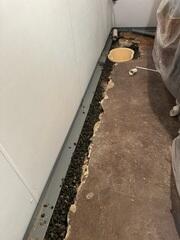WaterGuard was installed under the floor slab and against the wall to collect any water seepage from the wall to direct towards the sump pump.