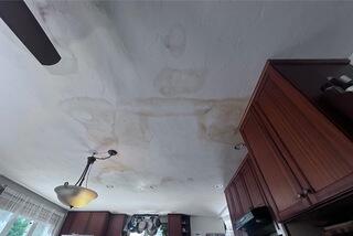 Water stains and active leaks were clearly visible on the ceiling of Philip's kitchen. The aging flat roof above was no longer keeping the elements out, and the damage inside was getting worse with each storm.