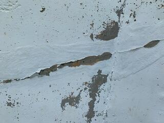 Upon inspection, hairline cracking was found along the base of the foundation.
