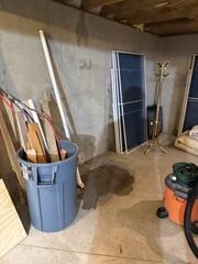In Bruce's basement, water was coming in and pooling in one area. There was a crack running from the floor to the ceiling that had water slowly seeping in and dripping onto the floor, creating that large wet spot.