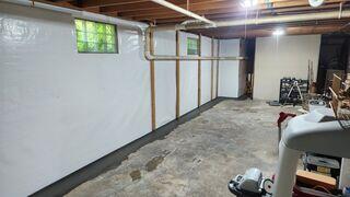 This photo shows the same wall as the last picture, but this picture was taken after the wall was fitted with our CleanSpace vapor barrier.