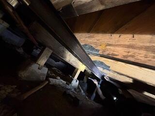 Tightening the jacks to permanently stabilize the home.