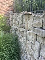 This retaining wall was failing and if left unattended, the problem worsens!
