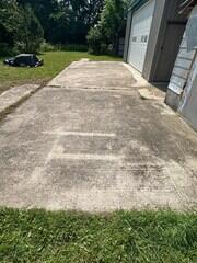 Before cleaning, the concrete pad was heavily covered in grime.