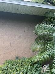 Large, stair-step pattern wall cracks had developed in the walls of the home, indicating to the homeowner that the foundation had settled.