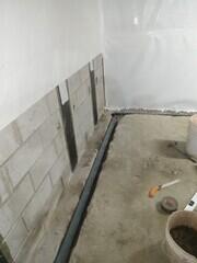 Wall membrane and drainage system added.