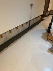Typical waterproofing systems are placed too deep, resulting in clogging. Our system is laid above the footing to prevent the soil from clogging.