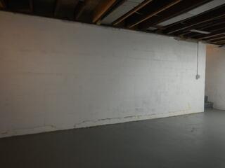 This basement/foundation wall was bowing inward and needed reinforcements to ensure it won't continue to get worse.