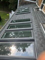 This photo highlights the final roof repair job with this home in Hanover, MA with the ten new Velux Skylights installed.