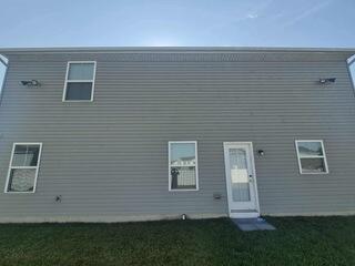 Before the soft wash, the vinyl siding on this home was covered in grime.