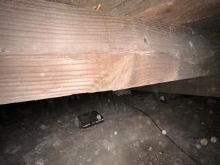 Over time, this main beam has weaken and now cracked which has made the wood loss all of it's integrity.