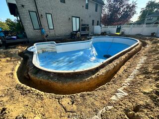 Our crew started by removing the existing patio and digging around the pool.