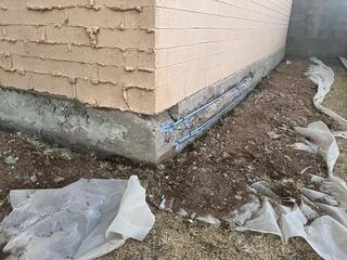 Plastic sheeting protects landscape - stem wall foundation