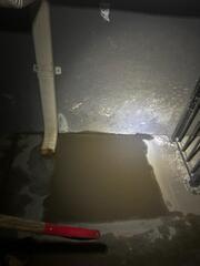 Fresh Concrete Patch by Downspout (Night) - home foundation repair in California