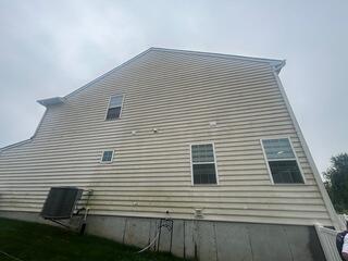 Before soft washing the vinyl siding on this home was covered in years of built up grime.