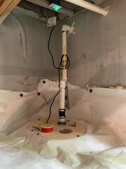 A sump pump system was set in place to remove groundwater and prevent standing water from damaging the foundation.