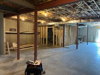 Here you can see the unfinished basement walls and the concrete floor that are exposed. The waterproofing system has not be installed quite yet.