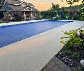 The newly installed Sugar Lake Durastone gives this Eau Claire pool deck a bright, slip-resistant, and elegant finish, perfectly complementing the backyard oasis.