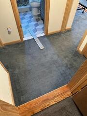 In this photo you can see the blue carpeting this homeowner previously had in their basement before our crew removed it and replaced it with our ThermalDry Elite Plank Flooring.