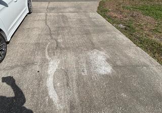 The homeowner's concrete driveway had developed numerous cracks and tripping hazards as the underlying soil had settled over time.
